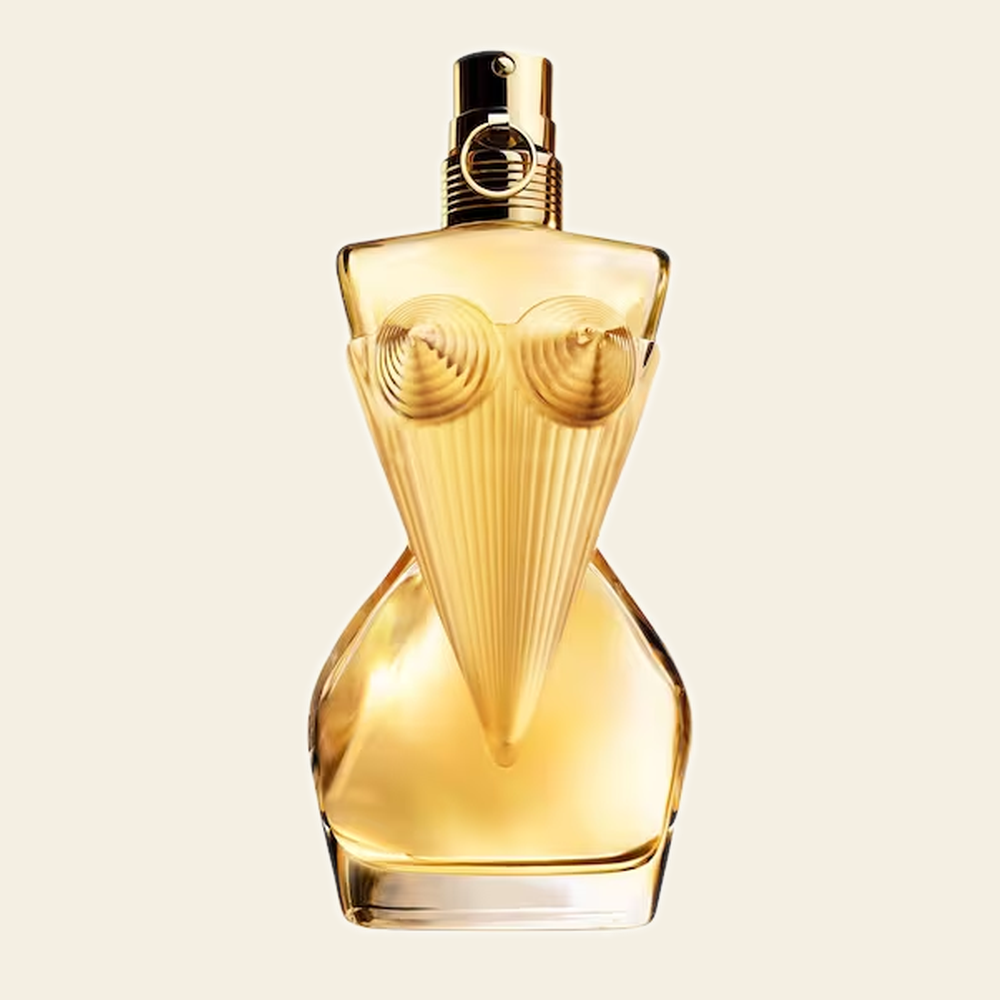 Flacon de parfum Divine par Jean Paul Gaultier sur fond ivoire
